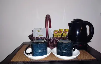 a basket with two mugs sitting on a table at Naturbliss Resort Village in Bangkok