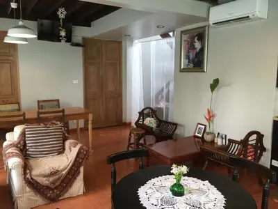 a living room with a table and chairs at Baan Ongkharak bed & breakfast in Bangkok