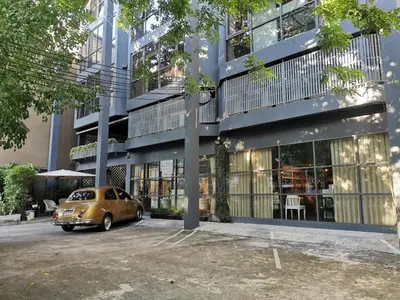 a car parked in front of a building at Collection O The Spades Hostel in Bangkok