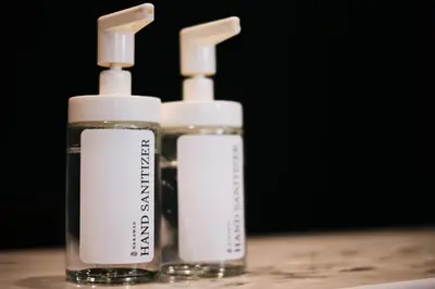 two bottles of soap sitting on top of a table at Narawad Boutique Hotel in Bangkok