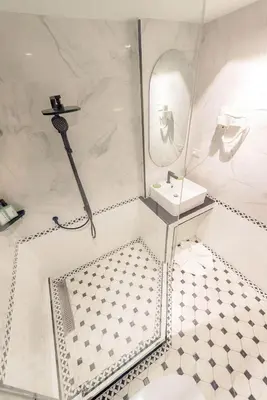 a white bathroom with a sink and a shower at Narawad Boutique Hotel in Bangkok