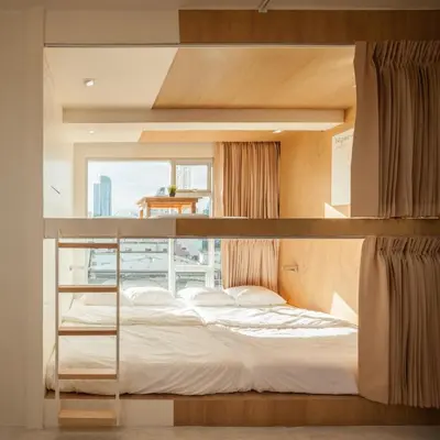 a bedroom with a bunk bed with a window at BoB Hostel บ็อบโฮสเทล in Bangkok