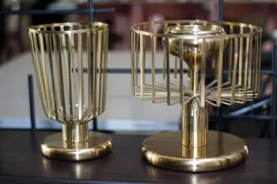 two gold trophies sitting on top of a table at Villa Baron SHA PLUS in Nonthaburi