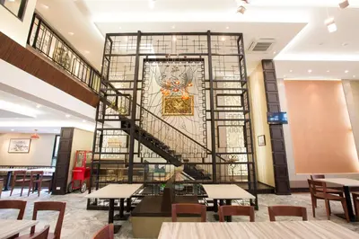 a staircase in a restaurant with tables and chairs at Villa Baron SHA PLUS in Nonthaburi