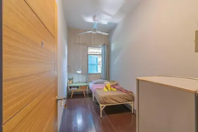 a bedroom with a bed and a window and a door at Sor Vorapin Muay Thai Home in Bangkok