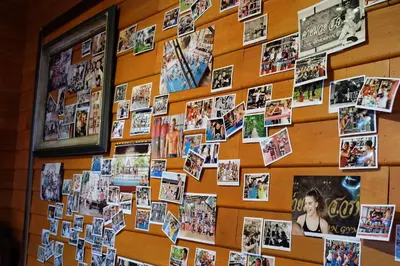 a wall with photos of people on it at Sor Vorapin Muay Thai Home in Bangkok