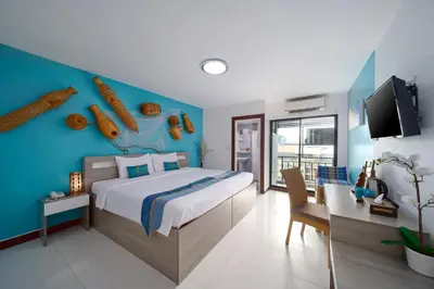 a bedroom with a bed and a blue wall at Baan Thai Boutique in Bangkok