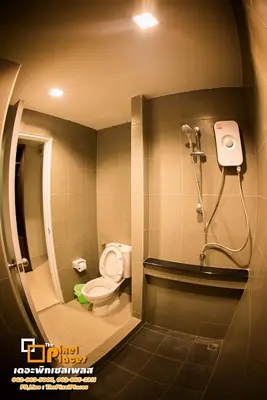 a bathroom with a toilet and a shower at The Pixel Places in Nonthaburi