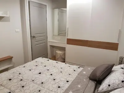 a small bedroom with a bed and a mirror at Rich Park@Tao poon interchange in Bang Su