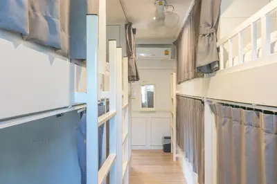 a hallway of an rv with curtains and wood floors at Ratana Boutique Hostel in Bangkok