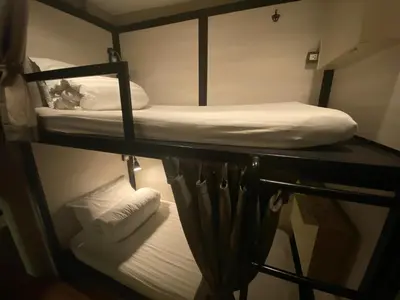 a room with two bunk beds and two towels at Augusta in Bangkok