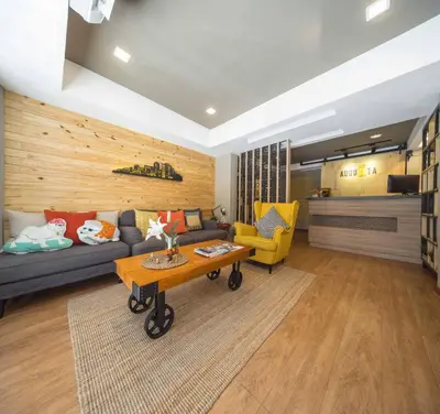 a living room with a couch and a table at Augusta in Bangkok