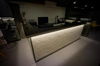 a lobby with a wall with a light on it at BRB Hostel Bangkok Silom in Bangkok
