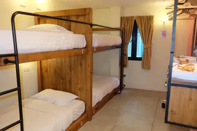 a room with three bunk beds in a room at Siri Poshtel Bangkok in Bangkok