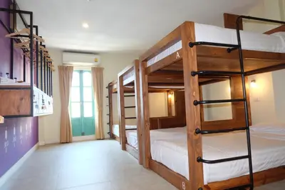 a room with three bunk beds in a room at Siri Poshtel Bangkok in Bangkok