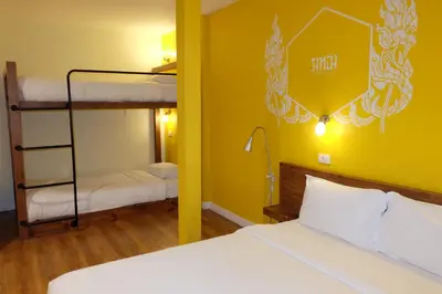 a bedroom with two bunk beds and a room with a bed at Siri Poshtel Bangkok in Bangkok