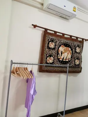 a towel rack on a wall with a picture on it at Indy house59 in Bangkok