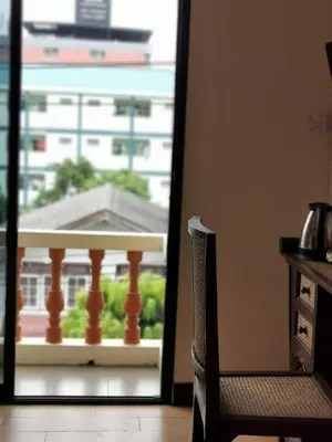 a door to a balcony with a view of a building at Indy house59 in Bangkok