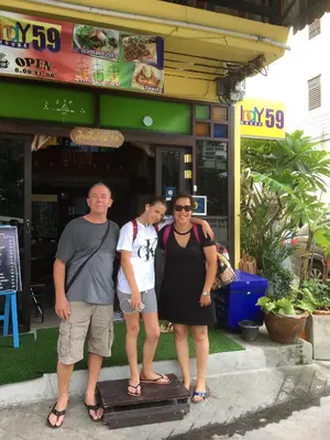 a group of people standing in front of a restaurant at Indy house59 in Bangkok
