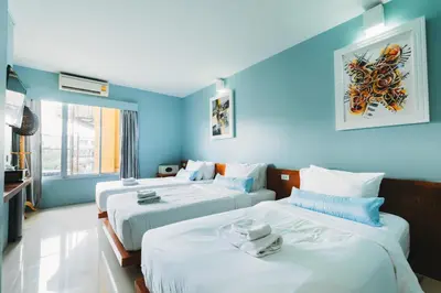 two beds in a room with blue walls at Villa Cha-Cha Khaosan Rambuttri in Bangkok