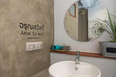 a bathroom with a sink and a mirror at Barn & Bed Hostel in Bangkok
