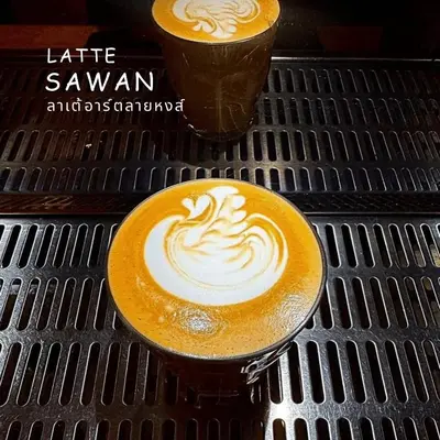 two cups of coffee sitting on a table at Barn & Bed Hostel in Bangkok