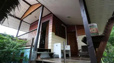 a porch of a house with a chair on it at Cast Away in Nonthaburi