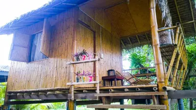 a house with a wooden wall and a balcony at Cast Away in Nonthaburi