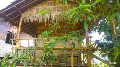 a bamboo house with trees in front of it at Cast Away in Nonthaburi