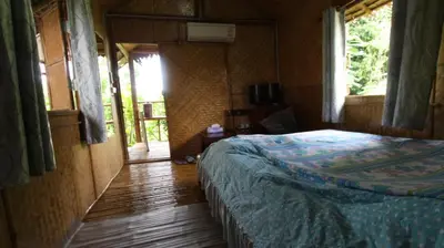 a bedroom with a bed in a room with a window at Cast Away in Nonthaburi