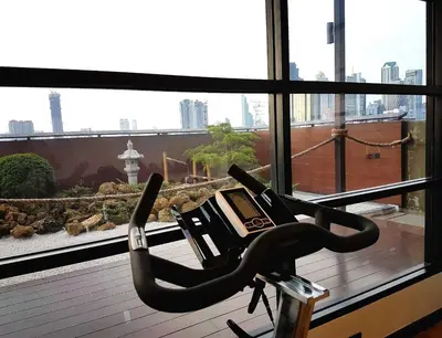 a gym seat in front of a large window at Zensation The Residence in Bangkok