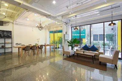 a living room with a couch and a table at Pula Silom in Bangkok