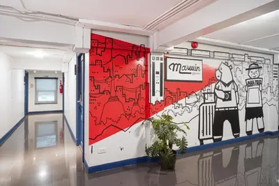 a wall in a hallway with a mural on it at Marwin Space in Bangkok
