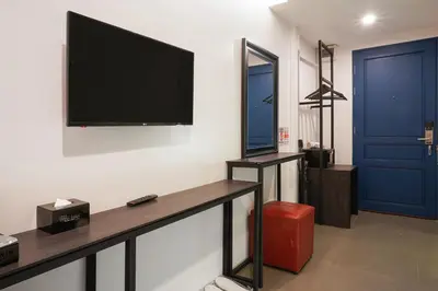 a living room with a flat screen tv on the wall at Marwin Space in Bangkok