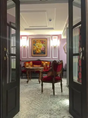 a living room with a couch and a table at Sara's Hotel in Bangkok