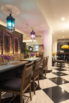 a dining room with a table and chairs at Sara's Hotel in Bangkok