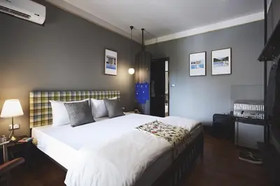 a bedroom with a large white bed in a room at Josh Hotel in Bangkok