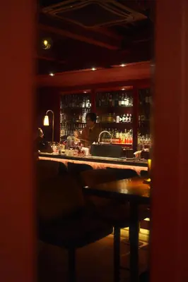 a bar with a man behind the counter of a bar at Josh Hotel in Bangkok
