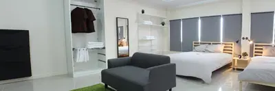 a bedroom with a bed and a chair at A18 in Nonthaburi