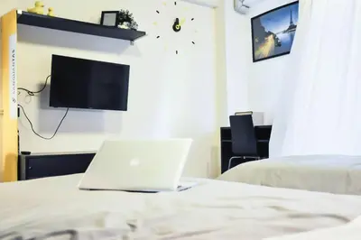 a bedroom with a laptop computer on a bed at A18 in Nonthaburi