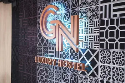 a sign on a wall that says flux university hospital at GN Luxury Hostel in Bangkok