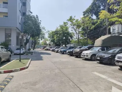 a row of cars parked on the side of a street at At 115 Hotel By Rompo in Bangkok