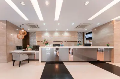 a lobby with people sitting at a reception desk at At 115 Hotel By Rompo in Bangkok