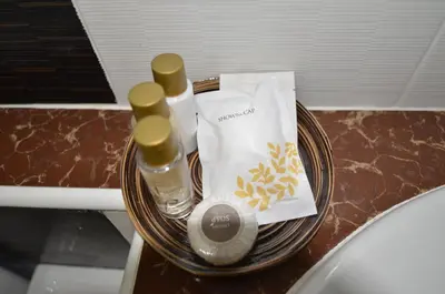 a table with two bottles of soap and a towel at The Best Place in Samutprakarn