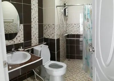 a bathroom with a toilet and a sink at The Best Place in Samutprakarn