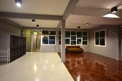 a living room with a couch in the middle at Inn Stations Hostel in Bangkok