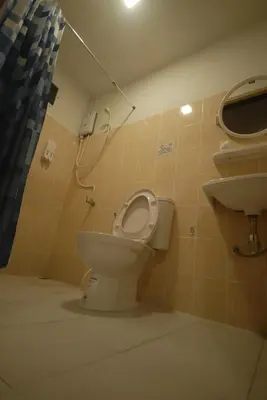 a bathroom with a toilet and a sink at Inn Stations Hostel in Bangkok