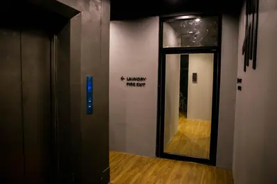 a door to a hallway with a sign on the wall at Silom Space Hostel in Bangkok
