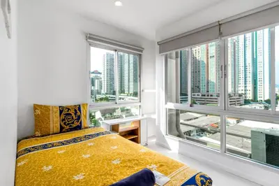 a bedroom with a bed and a large window at Right Place Sathorn in Bangkok