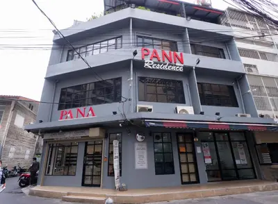 a building with a panini restaurant in front of it at Pann Residence in Bangkok